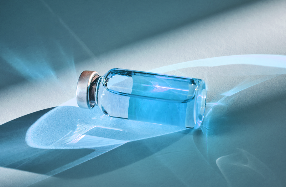 Laboratory glass vials on a soft blue background